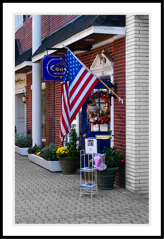 American flag hanging from a storefront.